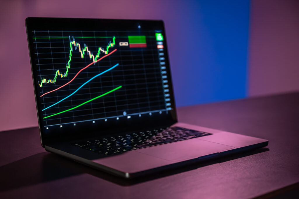 laptop screen with trading grid moving averages buy signal
